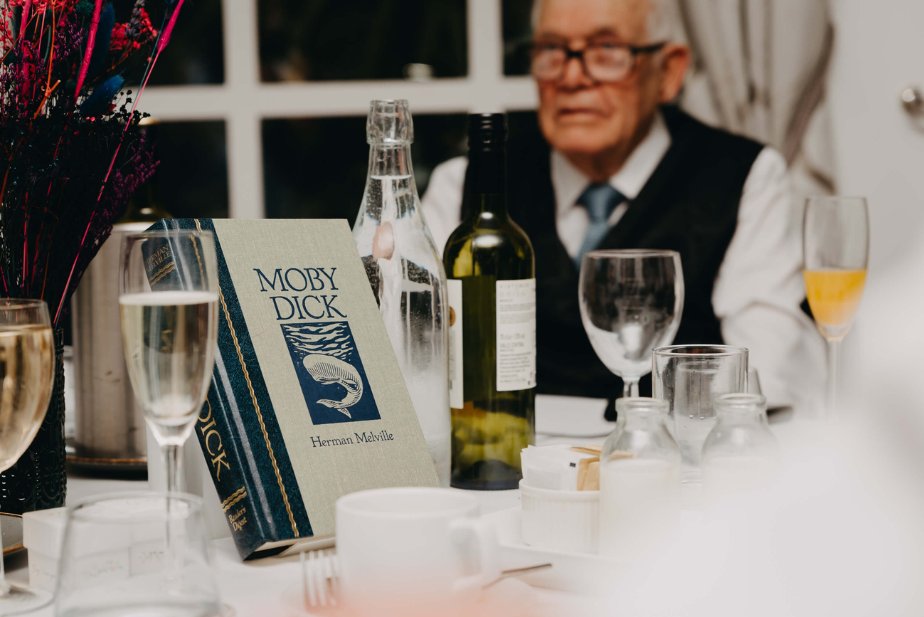 Moby-Dick by Herman Melville displayed as a creative wedding table decoration with colourful dried flowers