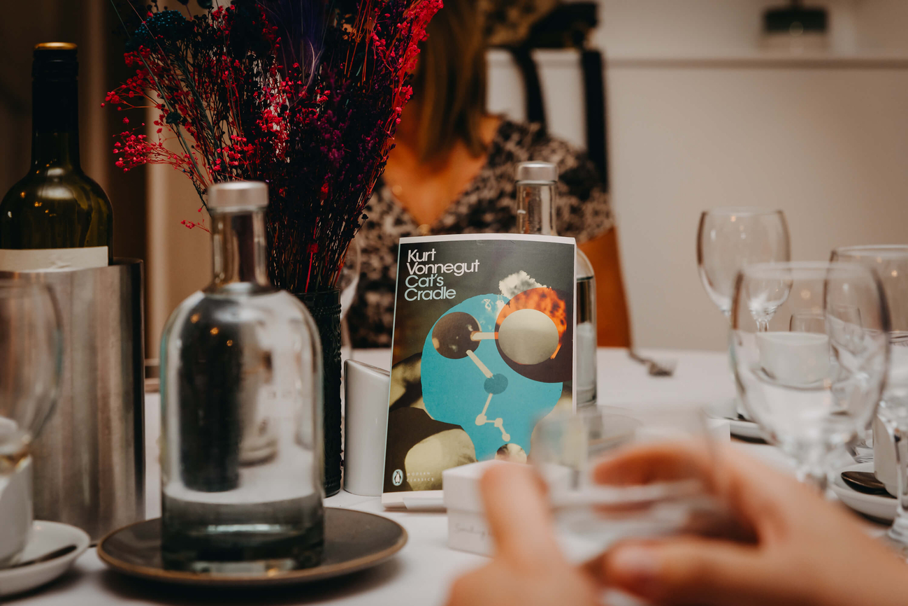 Cat's Cradle by Kurt Vonnegut used as a wedding table decoration alongside colourful dried flowers