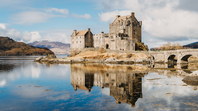 Eilean Donan Castle in the Scottish Highlands, surrounded by water and mountains